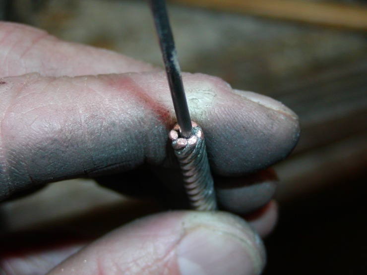 Detail of the tinned copper wires at their cut end on the mandrel.